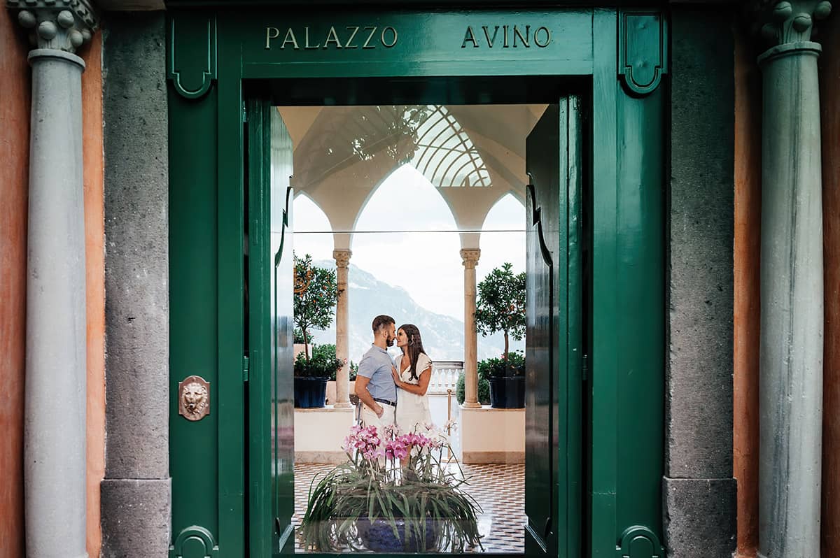 Kiss at Villa Monastero A couple shares a kiss framed by a grand green doorway at what appears to be Villa Monastero on Lake Como, Italy