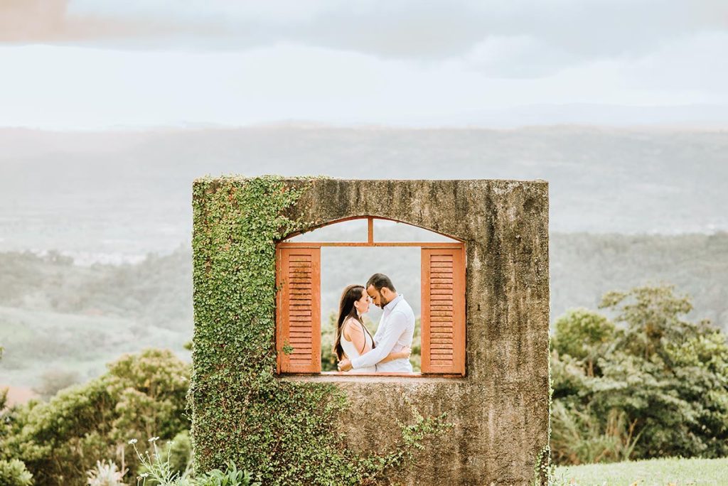 Bride and groom standing in a vibrant flower garden with colorful blooms, beautifully photographed by a Tuscany wedding photographer.