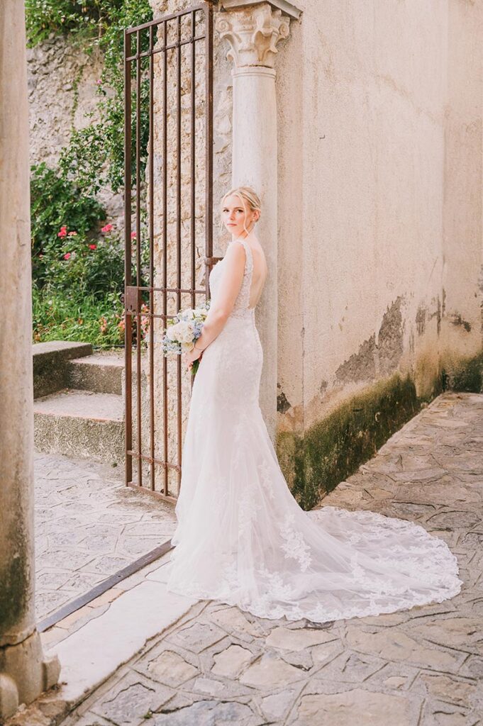Bride in a white gown walking down stone steps at Belmond Hotel Caruso wedding Ravello