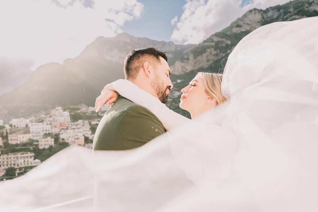 Romantic wedding in Santa Margherita Ligure with a loving couple embracing against the scenic Italian Riviera coastline