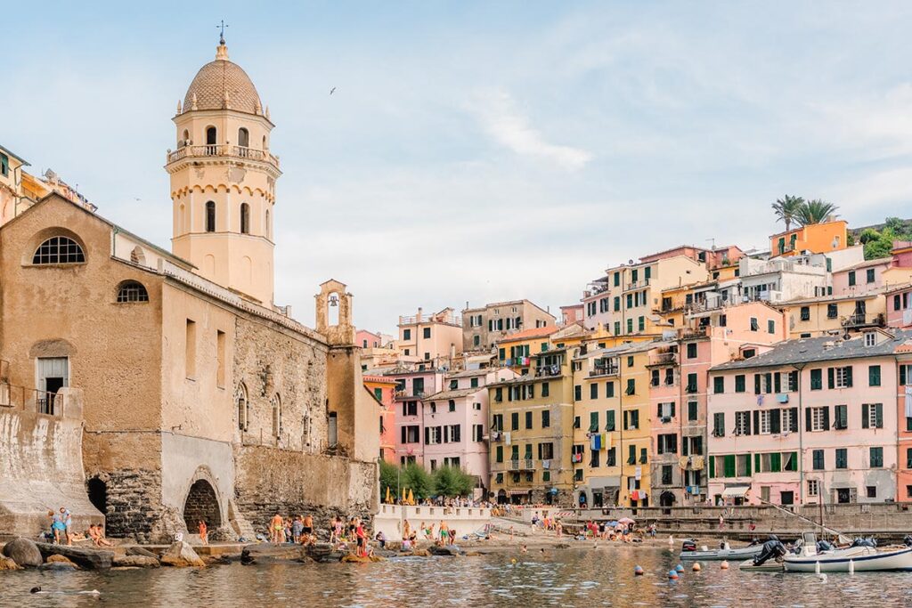 Italian Wedding Photographer captures a colorful Italian Riviera town with a church and harbor, highlighting the coastal charm
