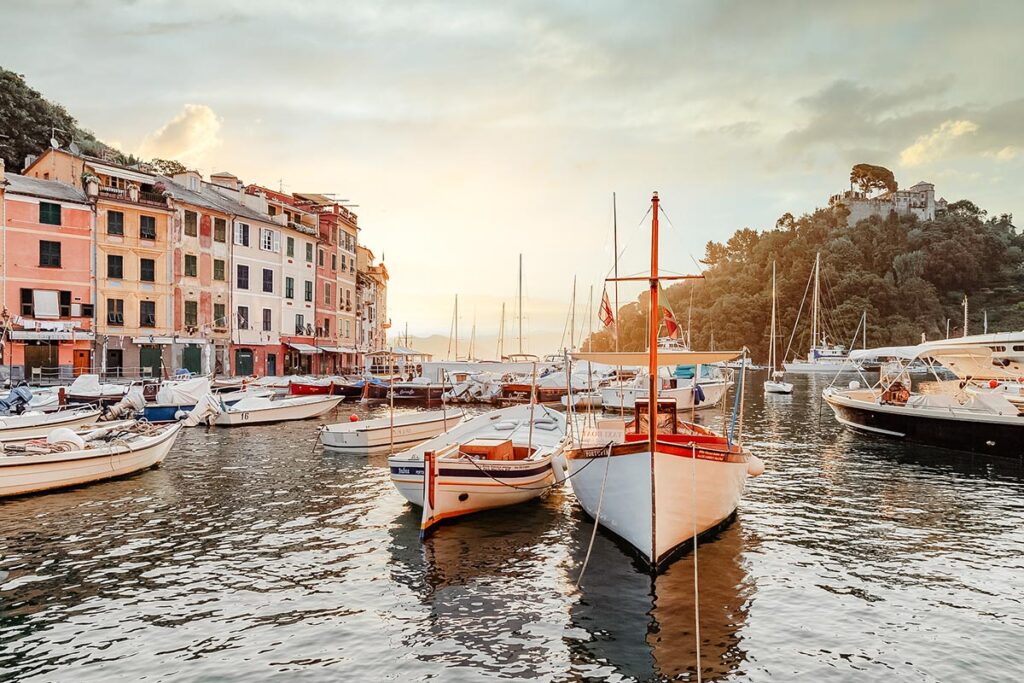 Italian Wedding Photographer captures the picturesque Portofino harbor with colorful buildings and boats, highlighting the romantic setting