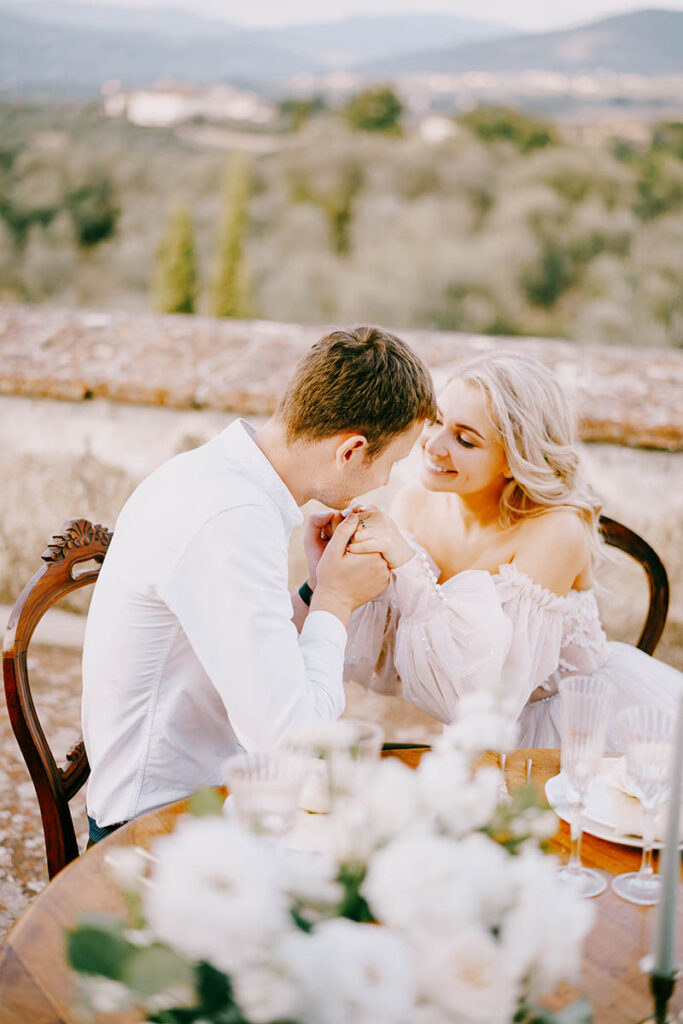 Romantic couple kissing at their Wedding in Arezzo, Tuscany, with a blurred natural background