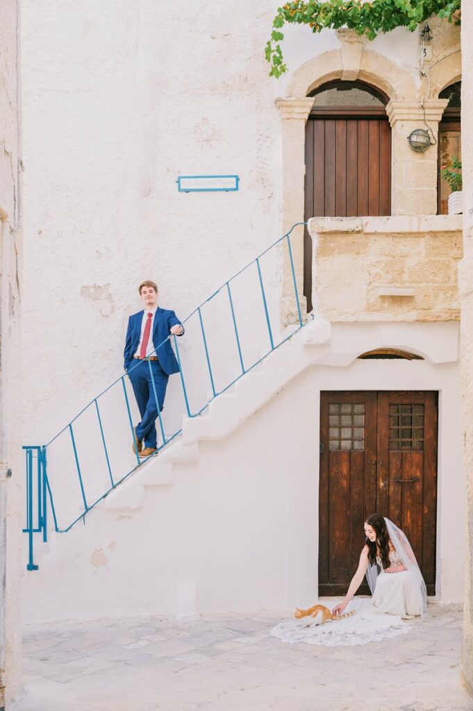 Wedding couple on stone staircase in a historic Apulian town, captured by a Puglia wedding photographer